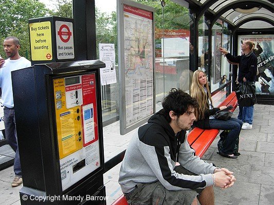 Bus stop in London showing ticket machine